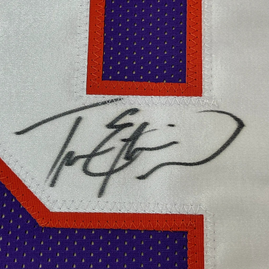 Autographed purple and white Travis Etienne Jr jersey with photos in a premium frame