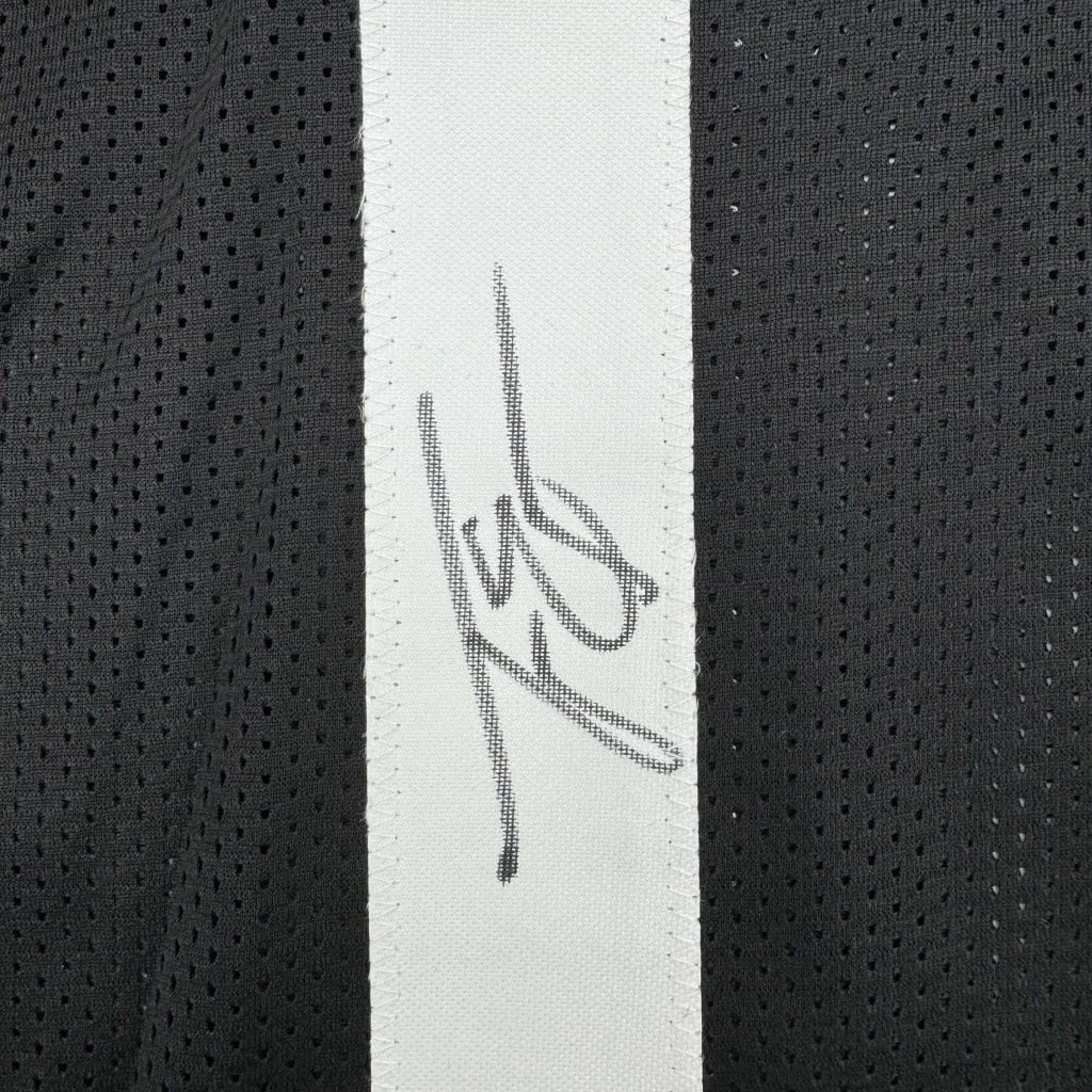 Black jersey with white stripe and faded signature, professionally framed Travis Etienne display