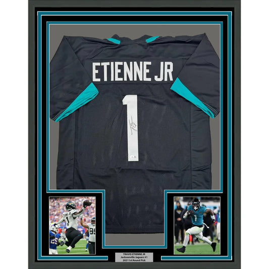 Framed Autographed Travis Etienne Jr. 35x39 Jacksonville Black Football Jersey Beckett BAS COA | Hall of Fame Sports Memorabilia | vintageantiquesgifts.com