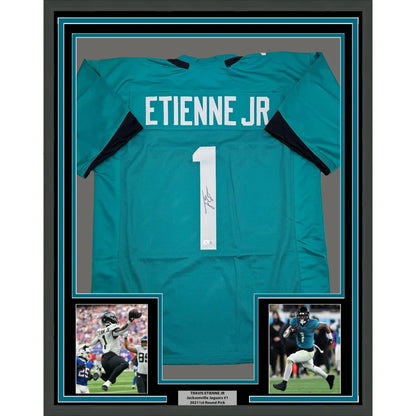 Framed Travis Etienne signed Jacksonville teal jersey with player photos and Beckett BAS COA