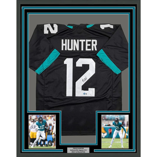 Framed Autographed Travis Hunter 35x39 Jacksonville Black Football Jersey Beckett BAS COA | Hall of Fame Sports Memorabilia | vintageantiquesgifts.com
