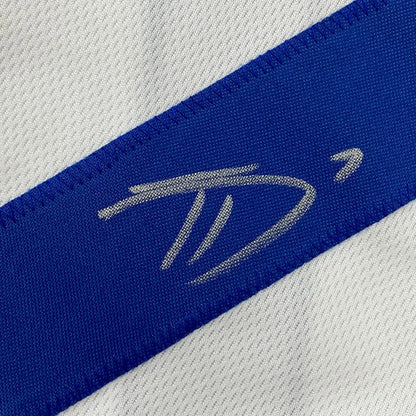 White and blue athletic fabric with silver embroidered logo on professionally framed Dallas Cowboys jersey