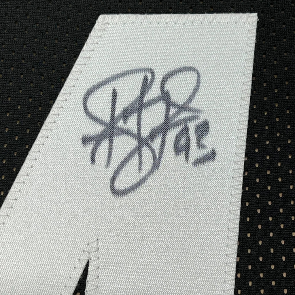 White fabric tag with stitched black ink Troy Polamalu signature on black mesh