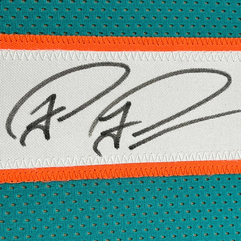 Autographed Miami Dolphins jersey fabric in framed Tua Tagovailoa memorabilia display