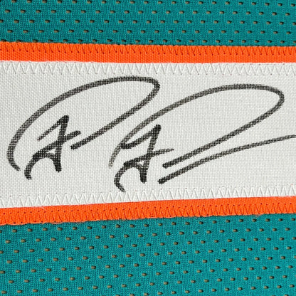 Autographed Miami Dolphins jersey fabric in framed Tua Tagovailoa memorabilia display