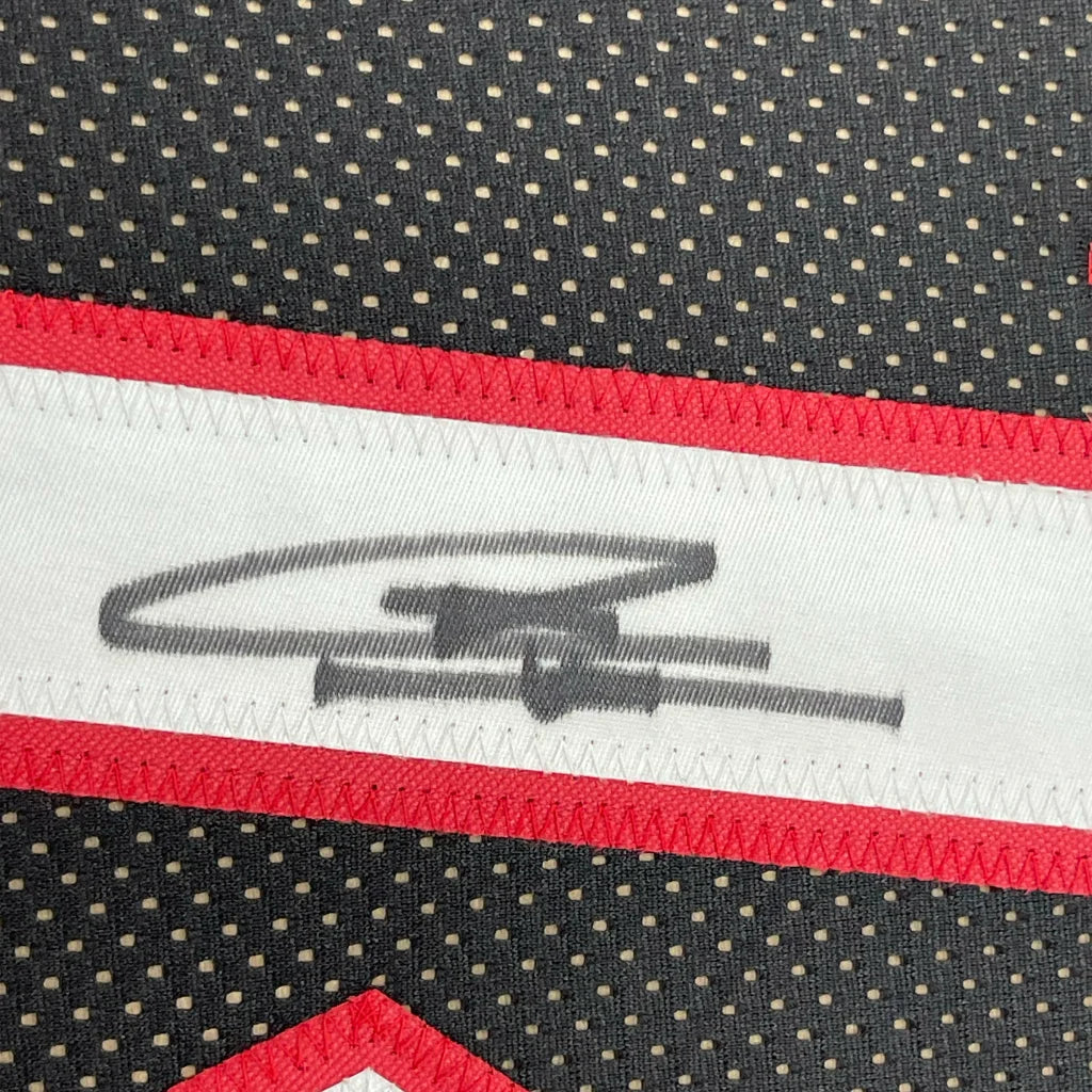 Black Miami Heat jersey with red white trim and signed autograph ready for display