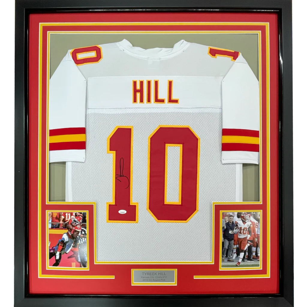Back side of a framed autographed white Kansas City Chiefs football jersey with red yellow accents signed by Tyreek Hill