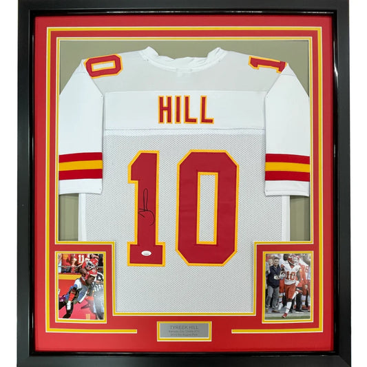 Back side of a framed autographed white Kansas City Chiefs football jersey with red yellow accents signed by Tyreek Hill