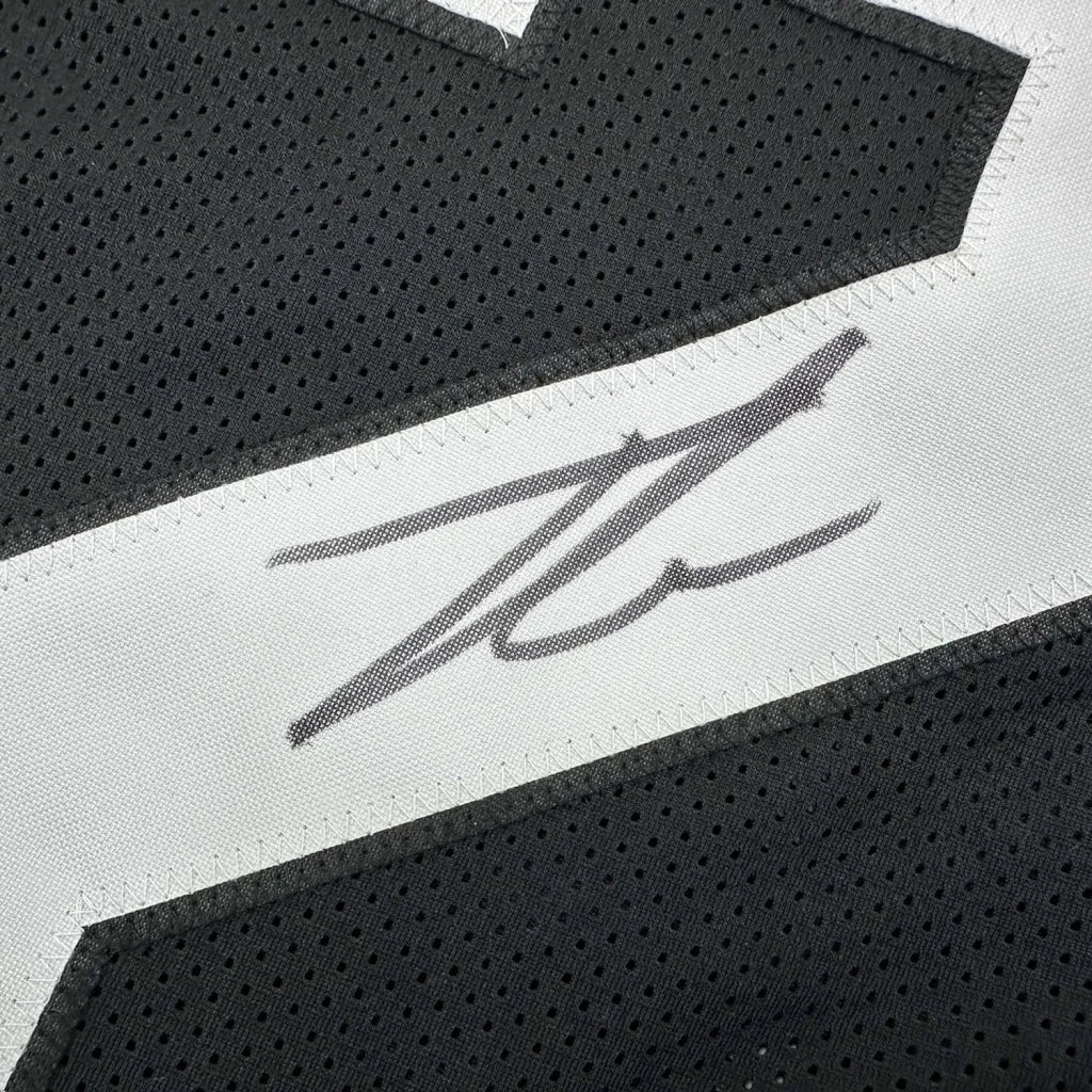 Autographed black football jersey with white accents from Framed Number 32 Jersey display