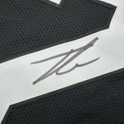 Autographed black football jersey with white accents from Framed Number 32 Jersey display