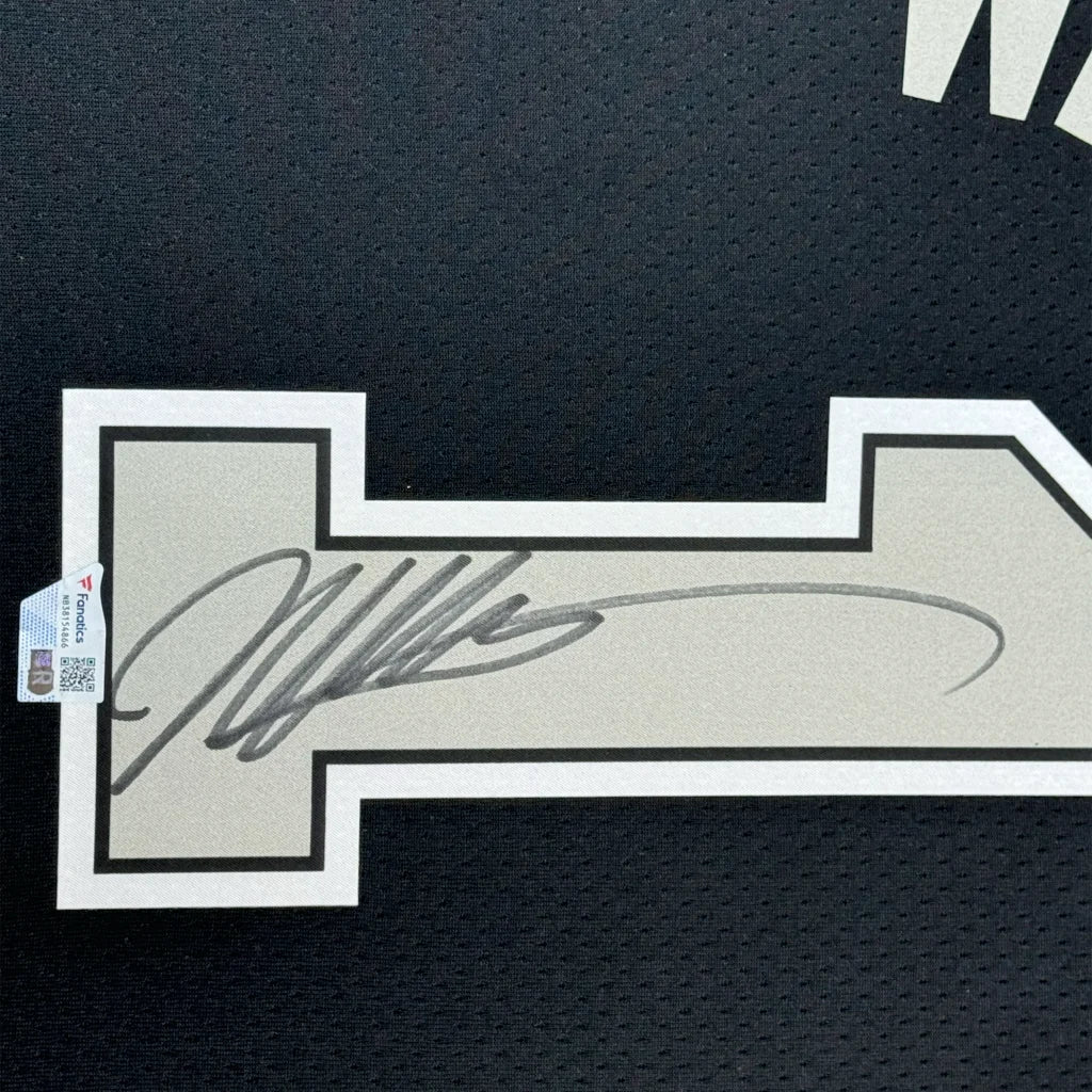 Autographed San Antonio Spurs jersey in a professionally framed man cave display