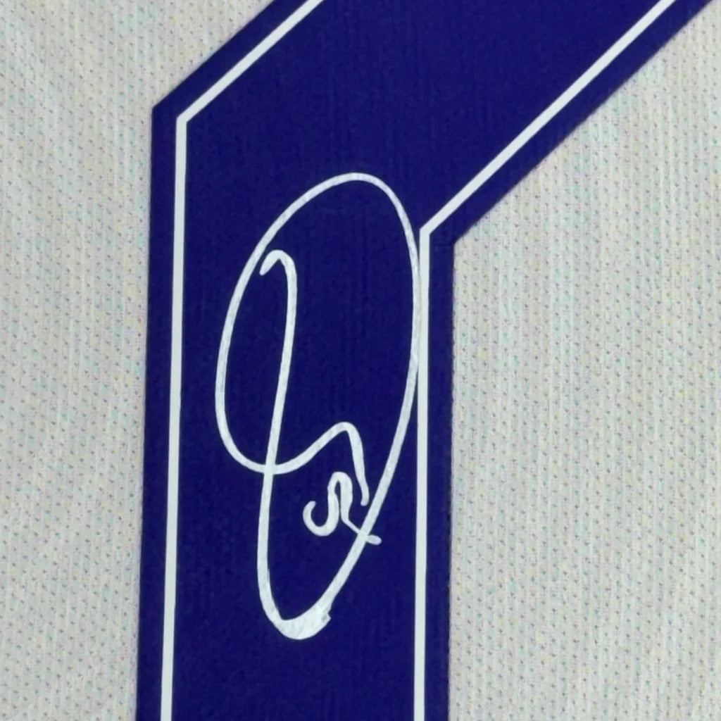 Blue and white number one patch with Vinicius Jr. signature on Real Madrid jersey