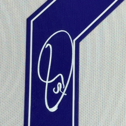 Blue and white number one patch with Vinicius Jr. signature on Real Madrid jersey