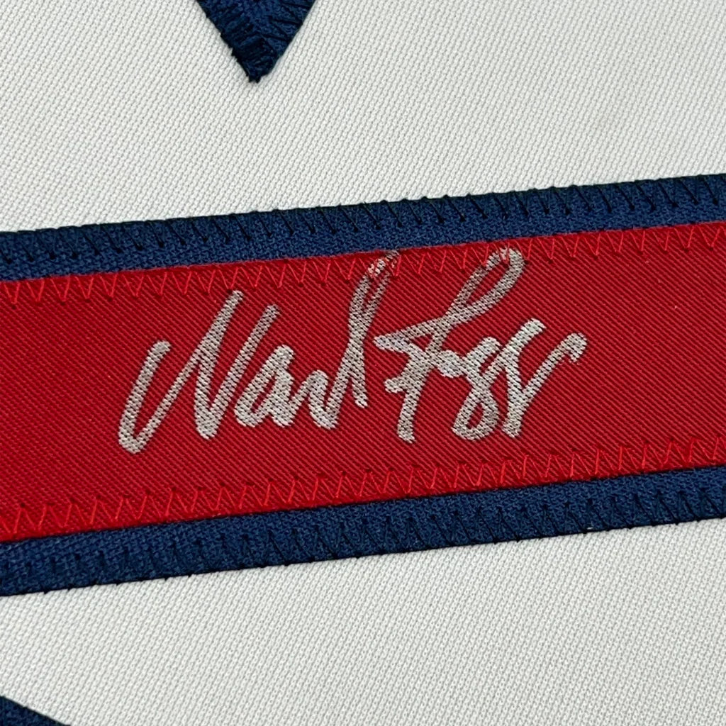 Close-up of Wade Boggs autograph and authentication details on framed Boston Red Sox white baseball jersey