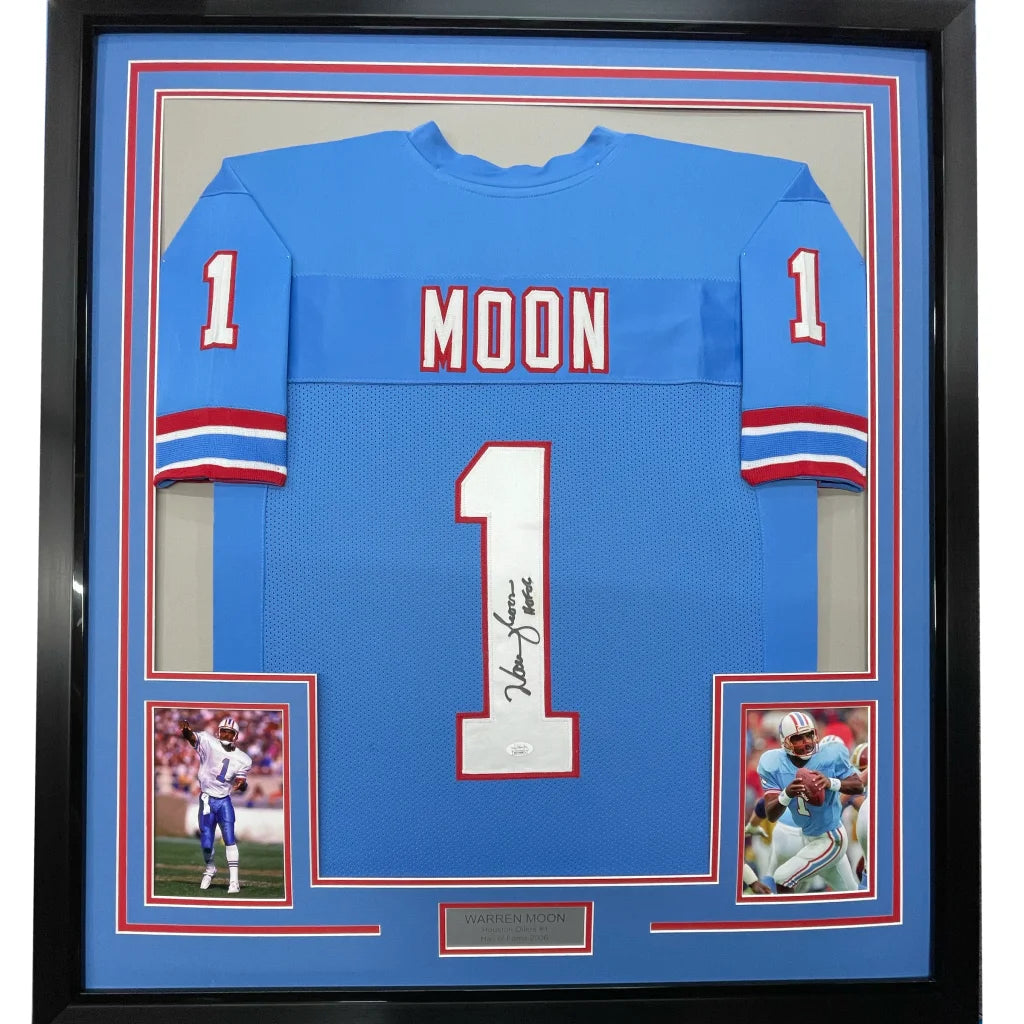 Framed light blue Warren Moon signed football jersey with two inset photos on display