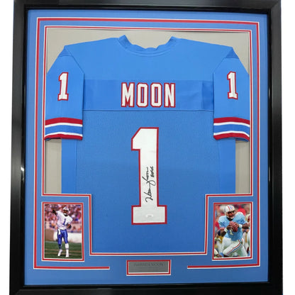 Framed light blue Warren Moon signed football jersey with two inset photos on display