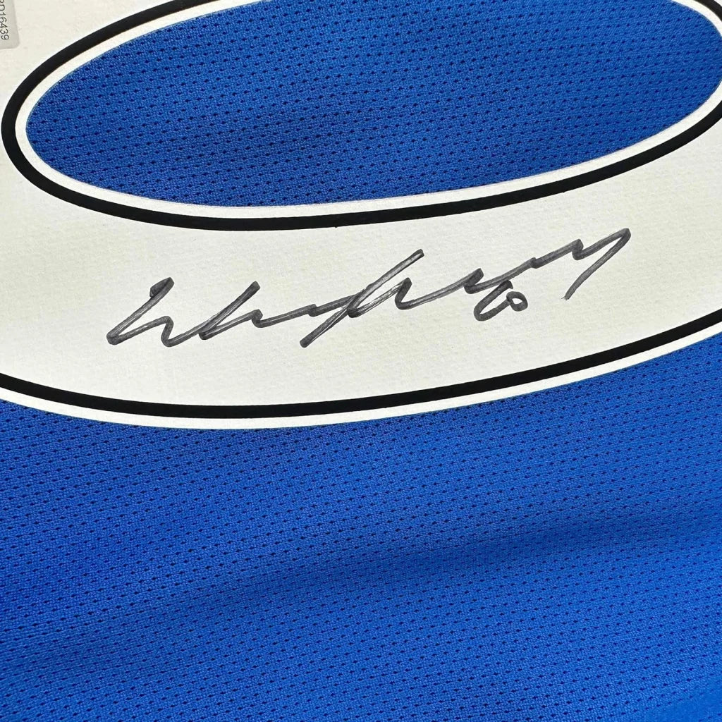 Blue and white Manchester United jersey with Wayne Rooney autograph, professionally framed