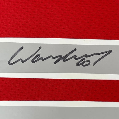 Red and gray striped fabric with a black signature from Wayne Rooney jersey