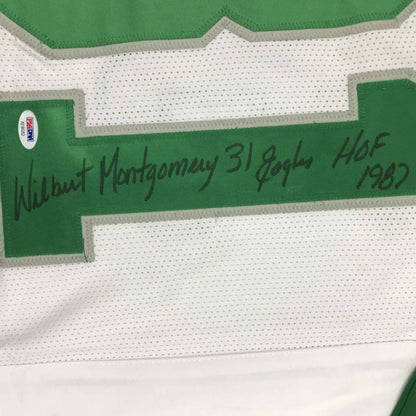 Autographed Green and White Eagles Montgomery Jersey displayed with Player Photos