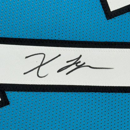 Black signature on white stripe of blue perforated athletic jersey in framed autographed Xavier Legette football jersey