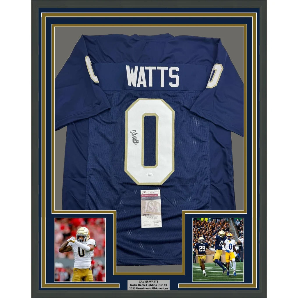 Back side of a framed autographed navy blue notre dame fighting irish football jersey with white number 0 and name watts