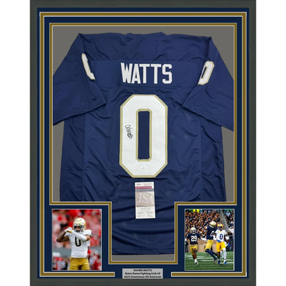 Back side of a framed autographed navy blue notre dame fighting irish football jersey with white number 0 and name watts