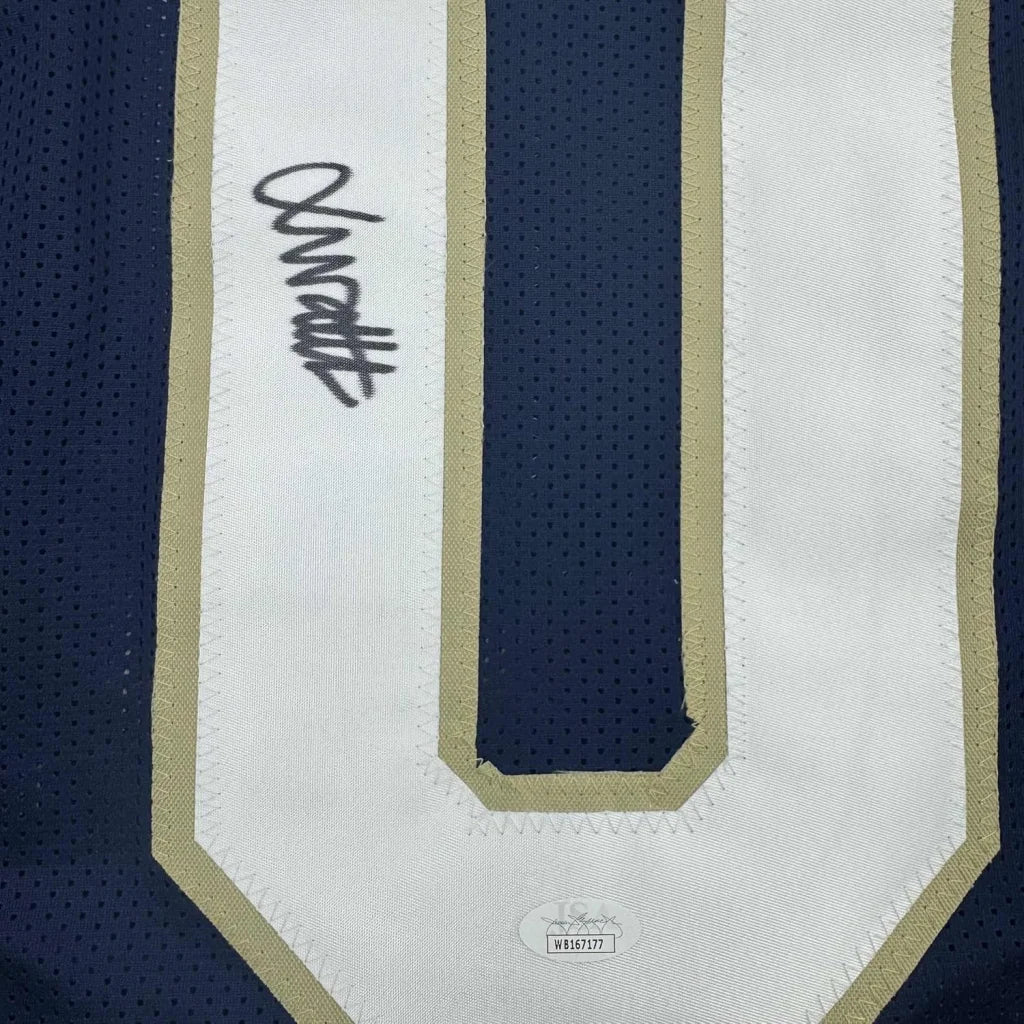 A navy blue and white mesh notre dame football jersey with gold trim featuring a signed white panel framed with JSA COA