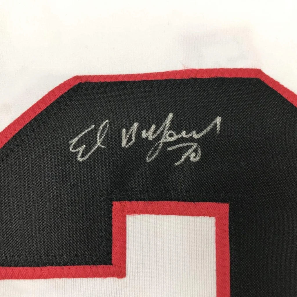 Autographed black and red Ed Belfour Blackhawks jersey with photos displayed