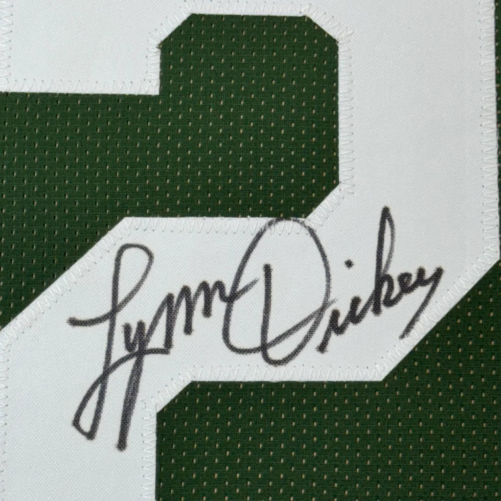 Green sports jersey with white number 2 and signature from Lynn Dickey in frame