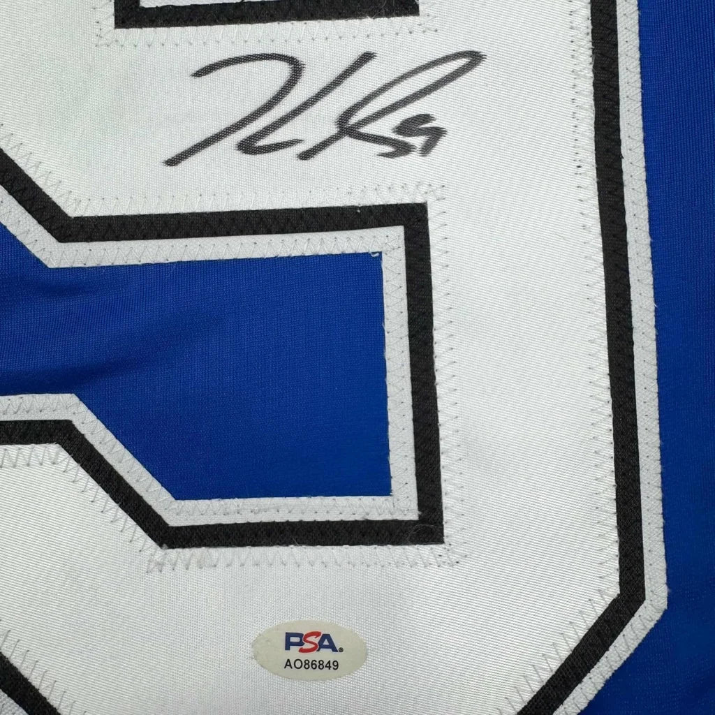 Blue and white Guentzel signed hockey jersey with authentication sticker for wall display
