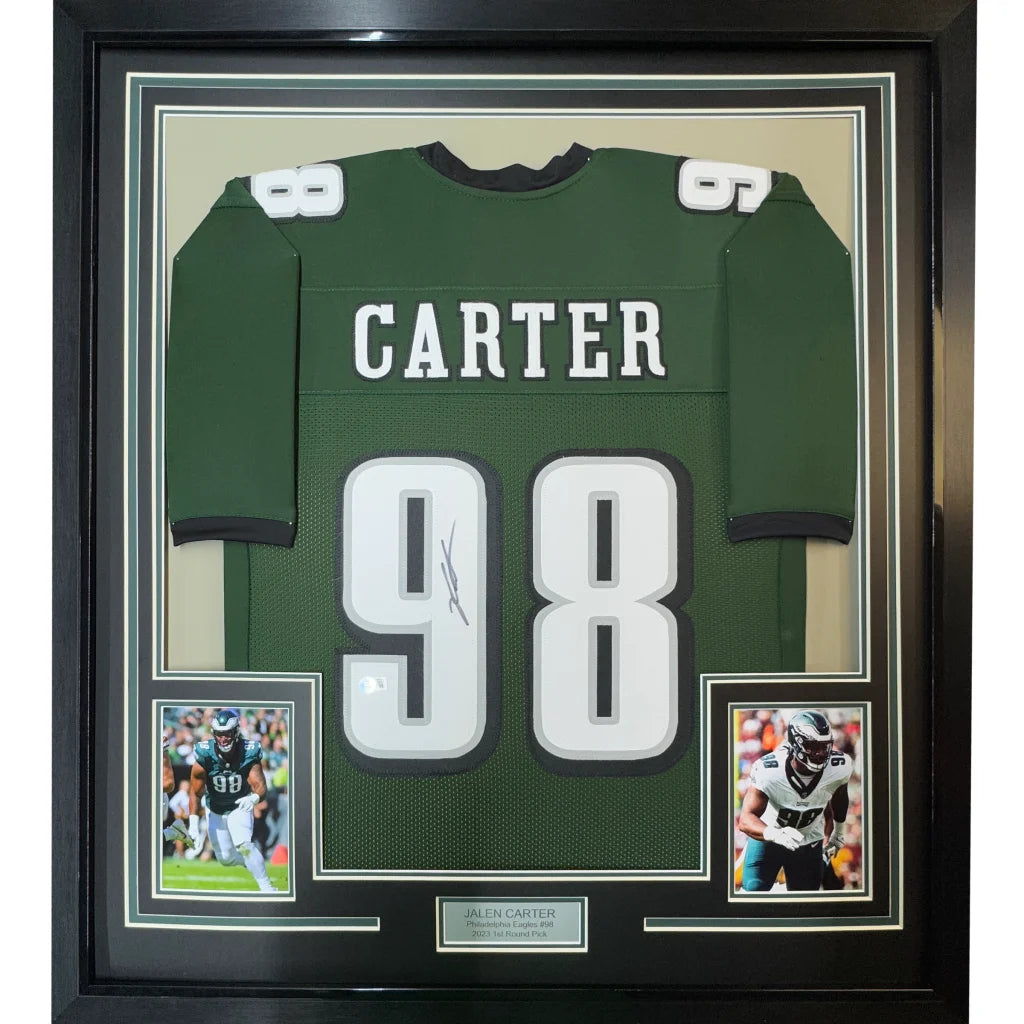 Framed Jalen Carter Eagles jersey with autograph and two player photos on display