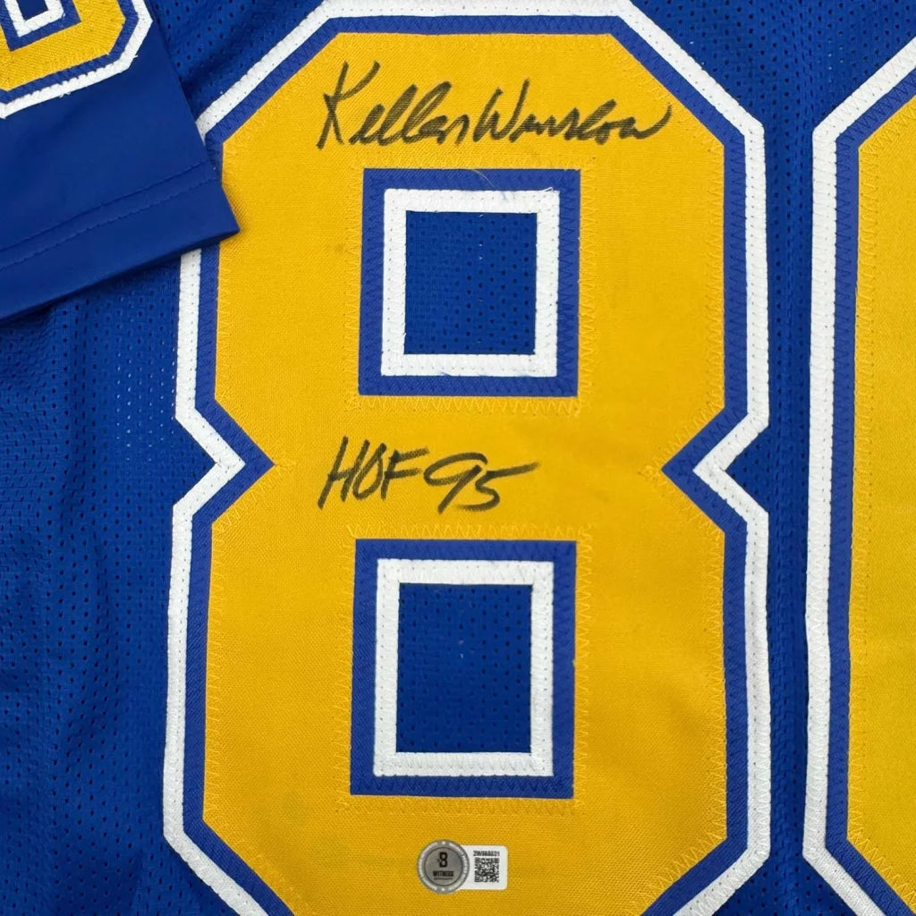 Autographed Blue and Yellow Chargers Jersey framed with photos of Kellen Winslow