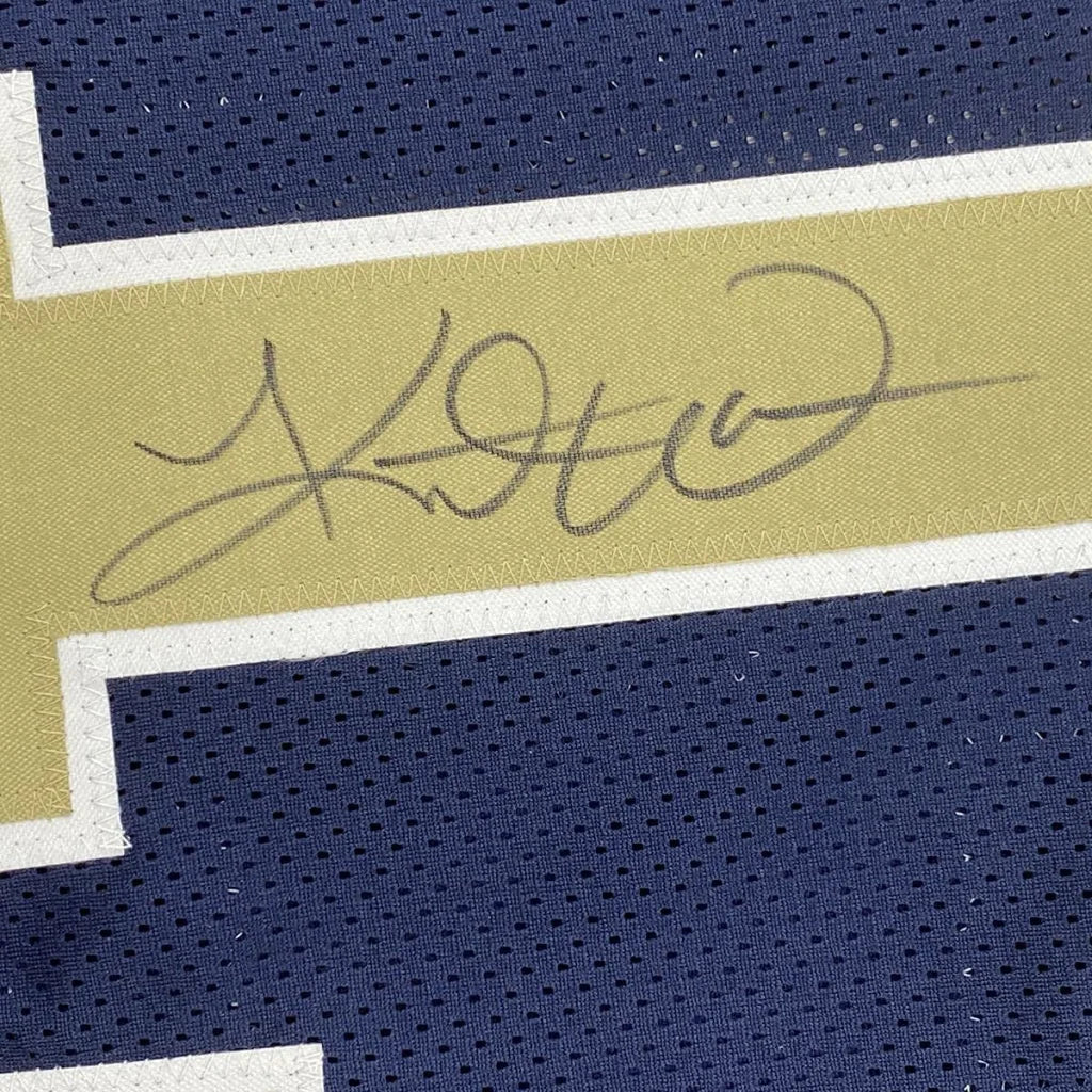 Navy blue Kurt Warner Rams jersey with gold and white stripe and autograph, ready to hang