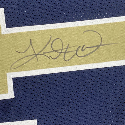 Navy blue Kurt Warner Rams jersey with gold and white stripe and autograph, ready to hang