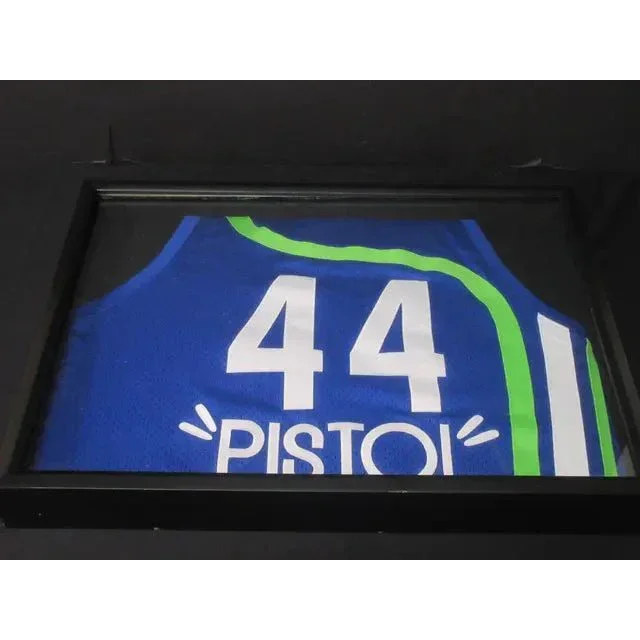 Framed Pete Maravich basketball jersey with number 44 in green and blue colors