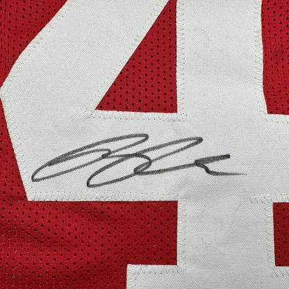 Red San Francisco 49ers jersey with white number 4 and black autograph ready to hang