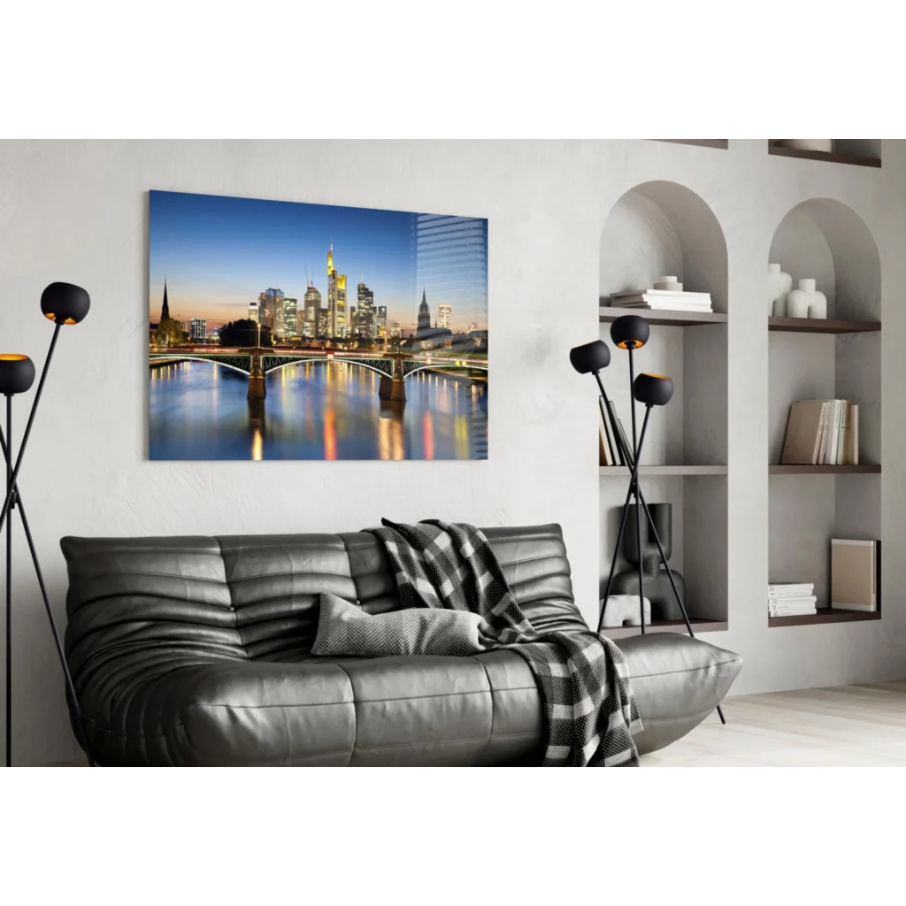 Black leather sofa with quilted texture and gray plaid throw over Frankfurt Skyline Twilight wall art