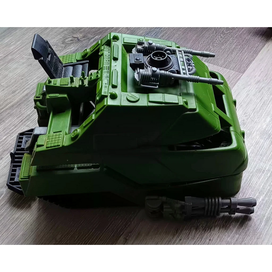 Green Hasbro mobile battle bunker toy tank transforming into robot warrior