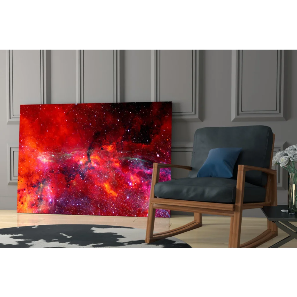 Vibrant red pink cosmic nebula glass wall art leaning on gray paneled wall