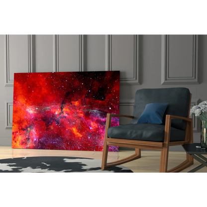 Vibrant red pink cosmic nebula glass wall art leaning on gray paneled wall
