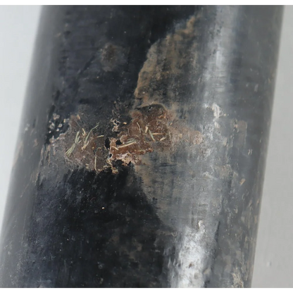 Damaged black pipe with corrosion, related to Noelvi Marte signed baseball bat product