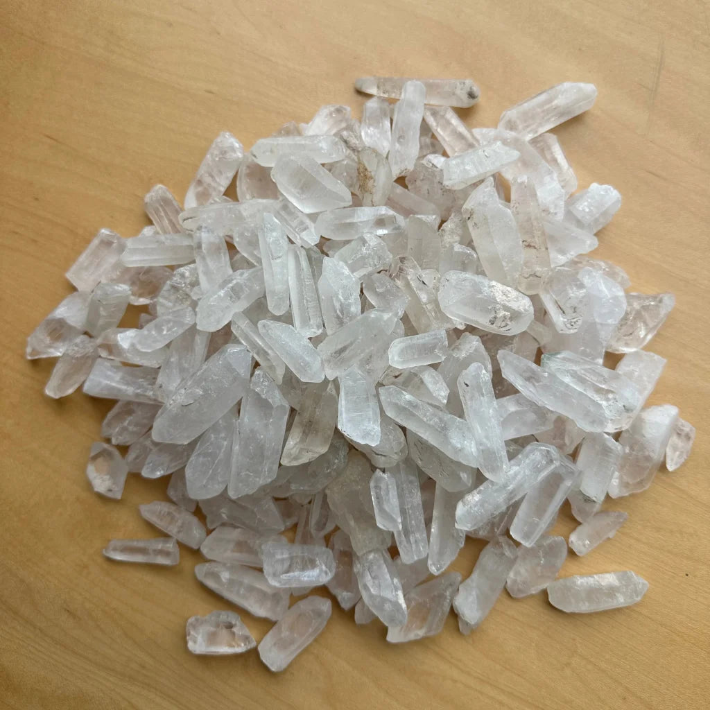 Pile of genuine Brazilian quartz crystal points with jagged edges