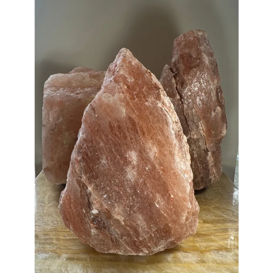 Rough pink Himalayan salt lamp crystal with natural texture and veins
