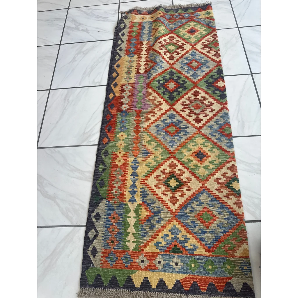 Handwoven geometric kilim rug set in vibrant red, green, blue and beige with fringed edges