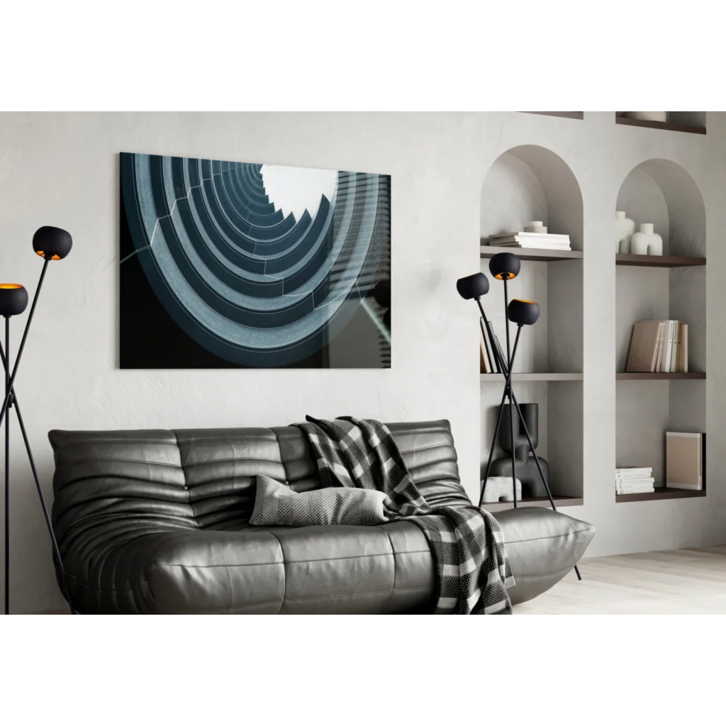 Black leather sofa with plaid throw over glass wall art