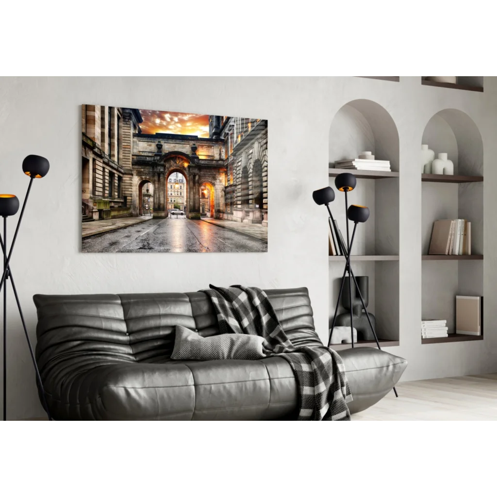 Black leather sofa with tufted cushions and checkered throw atop Golden Archway Sunset glass wall art