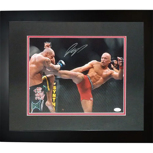 Signed deluxe framed 11x14 photo of Georges St. Pierre in action with opponent wearing red and black green shorts