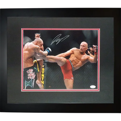 Signed deluxe framed 11x14 photo of Georges St. Pierre in action with opponent wearing red and black green shorts