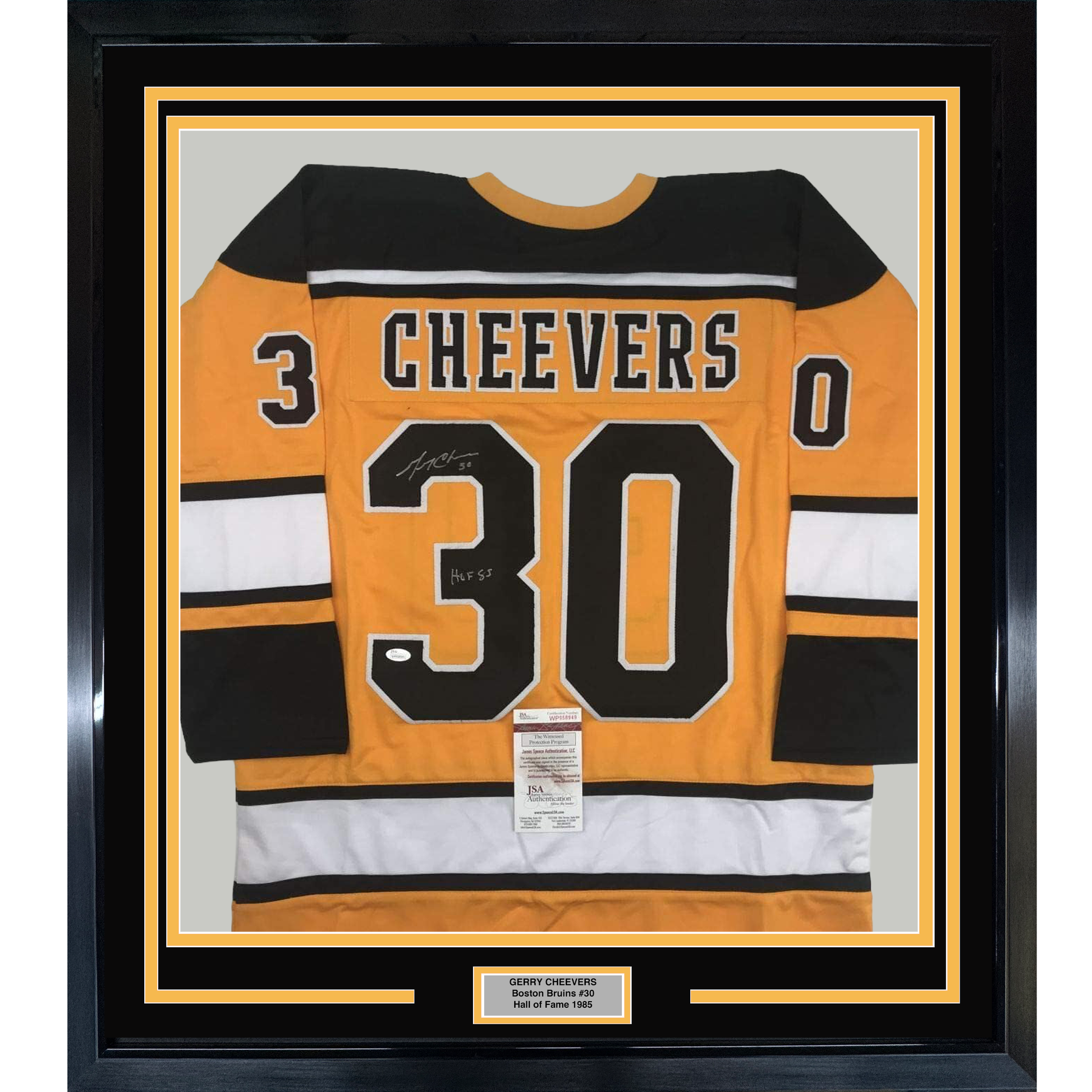 Framed orange and black Boston Bruins #30 jersey signed by Gerry Cheevers with HOF 85 inscription and JSA authenticity certificate displayed front-facing.