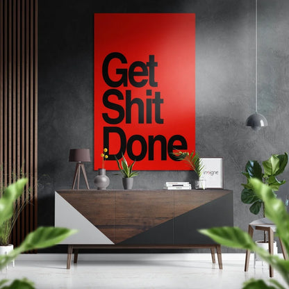Bold red Get Shit Done poster on brushed aluminium dibond above console